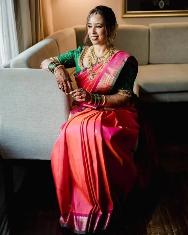 The quintessential Maharashtrian bridal look. This bride is glowing in her pink and orange Paithani saree, which I pre-pleated to highlight its rich colors and traditional design.
