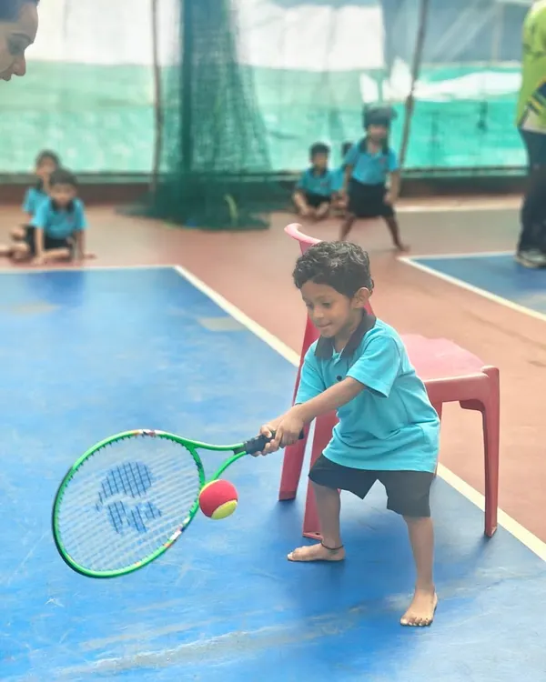 It all starts here. A young player in our Mini-Tennis program learns the fundamentals of a forehand, focusing on making clean contact with the ball. We make learning fun and effective from the very first swing.
