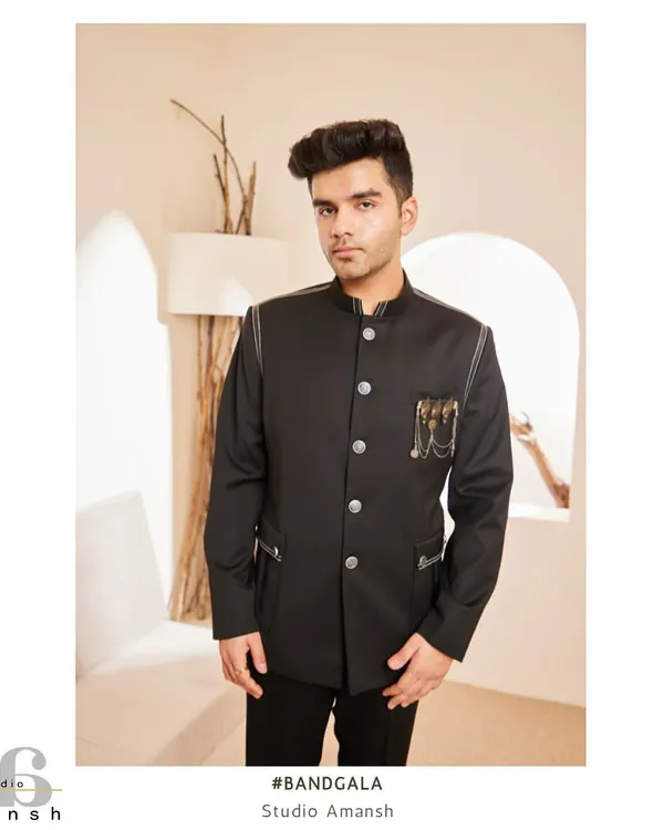 This is our signature black Bandhgala, a modern classic. We tailor it for a sharp, commanding silhouette and add unique details like metallic embellishments and subtle leather piping to create a look that is both timeless and contemporary. It's the perfect choice for a formal reception or a high-profile evening event.