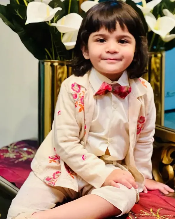 One of my little clients, Kavyansh, looking absolutely charming in a custom-designed beige suit. The jacket features delicate floral embroidery, paired with a matching shirt and a cute floral bow tie.