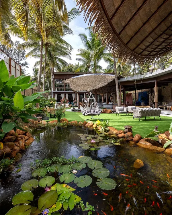 This tranquil backyard with its thriving lily pond and naturalistic landscaping blurs the line between the home and the garden, creating a private oasis.