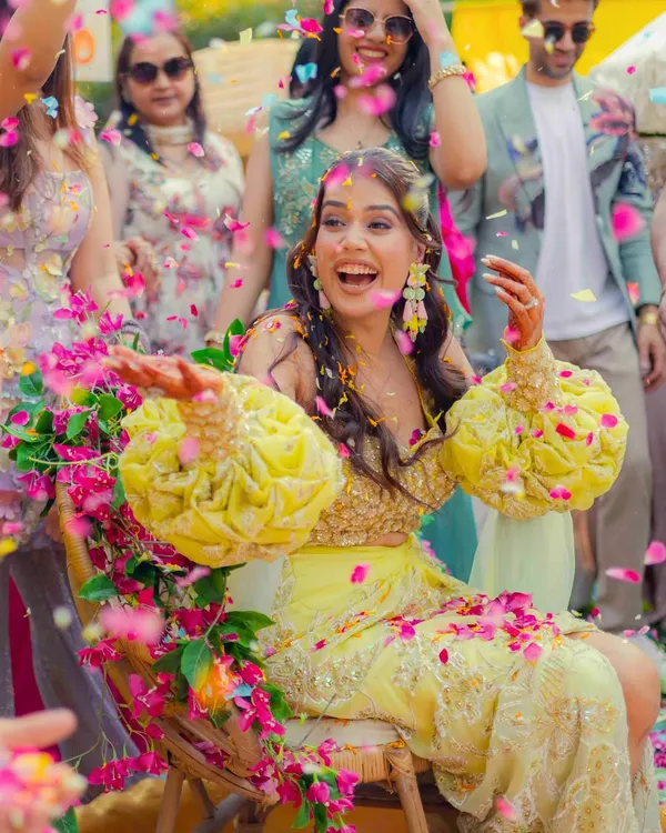 This is what pure, unscripted joy looks like. We live for these moments, like this vibrant 'phoolon ki holi' during a Haldi ceremony, where laughter is the most beautiful decoration. It’s the realness of your story that we aim to capture.