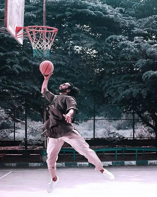 When I'm not lifting, I'm on the court. This creative shot combines my love for basketball with a bit of traditional flair.