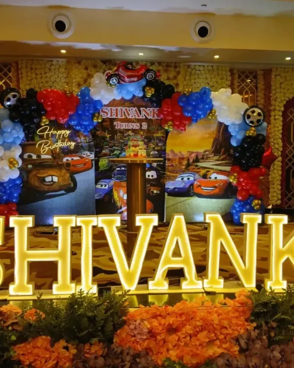 This is the kind of "wow" moment I love to create. For Shivank's second birthday, we went all-in on a Disney Cars theme, complete with a custom backdrop, a vibrant balloon arch, and giant light-up marquee letters spelling out his name. It makes for an unforgettable photo-op.