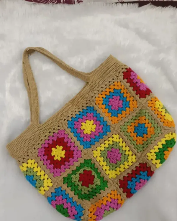 A full view of the vibrant granny square tote bag. Each square is crocheted and joined by hand to create this classic, eye-catching pattern.