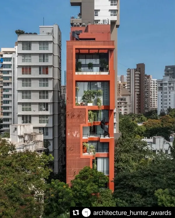 We believe architecture should not just occupy a space but enhance it. This award-winning vertical residence in Mumbai, Sarvasva, stands as a testament to our philosophy, wrapping a high-rise home in a terracotta skin and integrating cascading green voids to create a living structure that breathes with the city.