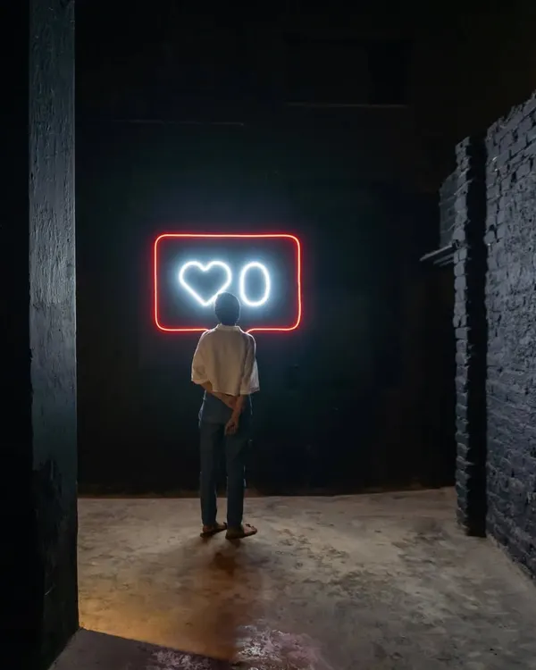 This is from my installation 'Surfing,' a commentary on our relationship with social media. The neon 'Heart 0' sign creates a powerful focal point in a dark, atmospheric space, inviting viewers to reflect on digital validation.