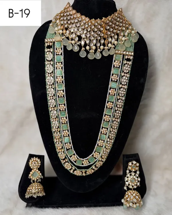 Set B-19 is a masterpiece in pastel green. It features a wide polki choker and a multi-strand long haar with pearl and stone detailing, perfect for a modern bride.