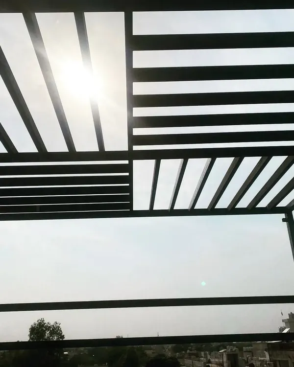 A view from underneath one of our modern MS pergolas. The slatted design creates interesting shadow patterns while providing partial shade from the sun.