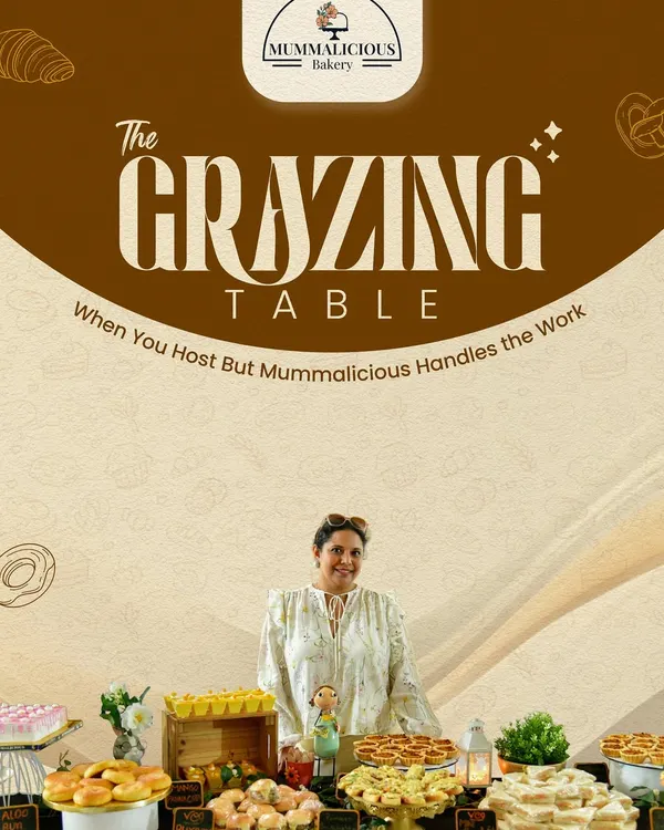 This is what we mean by hassle-free hosting. I'm pictured here with one of our complete grazing table setups, featuring a variety of desserts, snacks, and drinks, all styled and ready for guests.