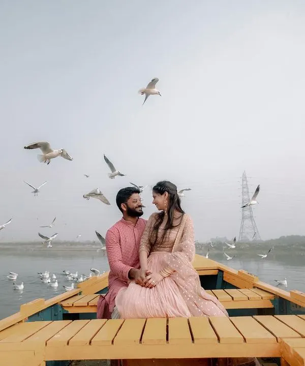 Our journey with you is about finding magic in unexpected moments. Here, on the serene waters of the Yamuna, surrounded by a flight of birds, we captured a tranquil moment of togetherness that feels like a scene from a timeless film.