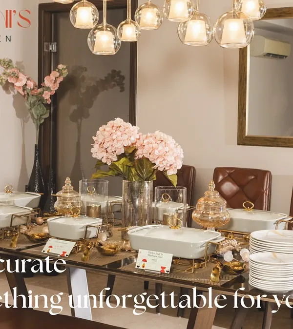 Let's curate something unforgettable for you. This image showcases an elegant and modern buffet setup with beautiful white and gold ceramic serveware.