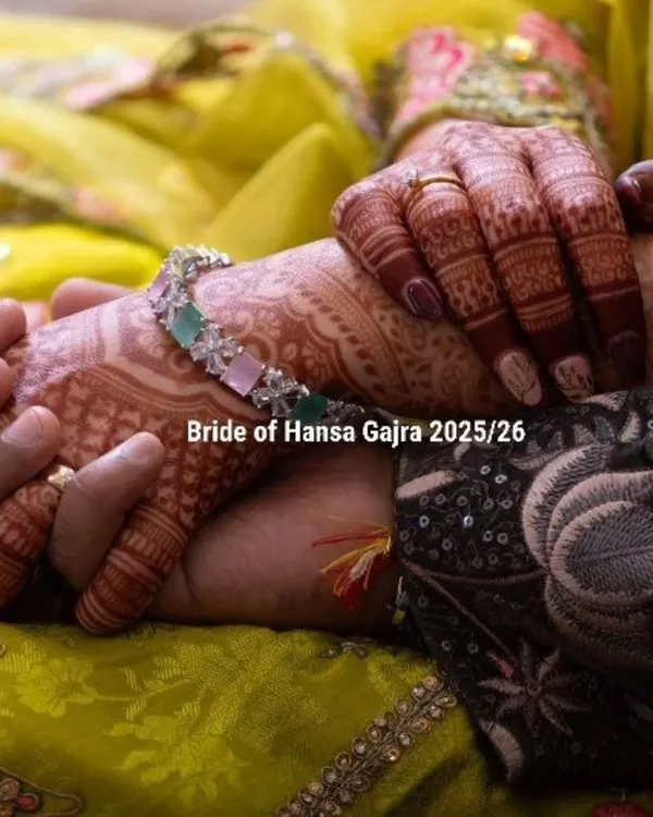 A beautiful shot of a bride's hands with colored mehendi, designed to complement her yellow and green outfit. The added color brings a modern charm to the traditional floral patterns.