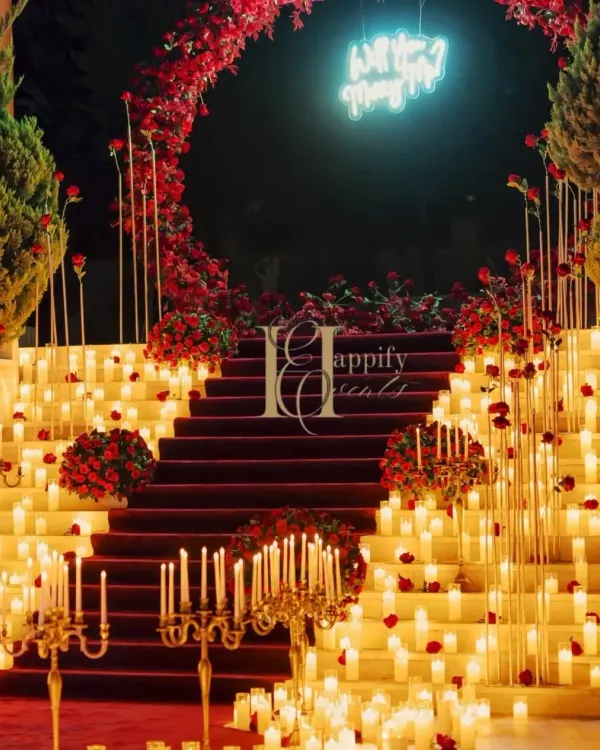 This grand proposal in Karjat is what dreams are made of. I used hundreds of candles, a lush red rose arch, and a custom neon sign to create an overwhelmingly romantic atmosphere for a truly unforgettable moment.