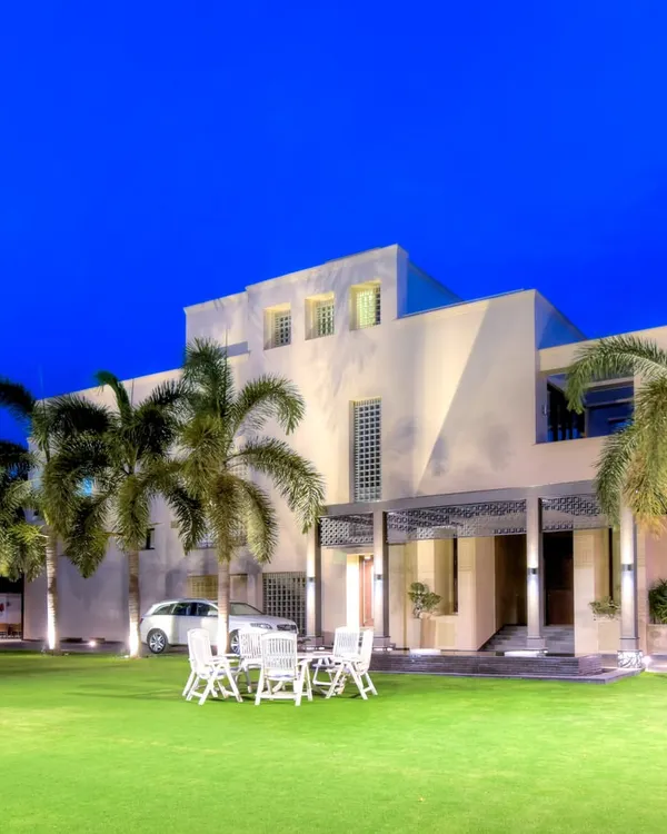 A view of a large residential property where the expansive, perfectly manicured lawn becomes the centerpiece. This space is designed for both large gatherings and quiet enjoyment, framed by mature trees and a modern home exterior.