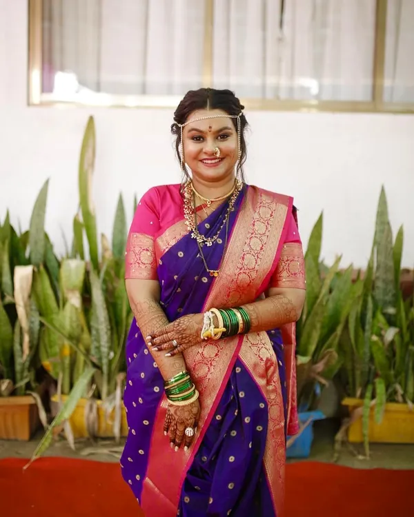 A full portrait of my beautiful Marathi bride in her purple navvari saree. The subtle makeup and natural glow perfectly complement her traditional attire for the wedding ceremony.