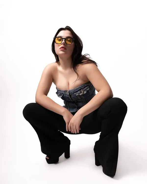 A full-body studio shot of a model in a denim top and bell-bottoms. This image showcases my use of clean, high-key lighting for a modern and edgy fashion look.