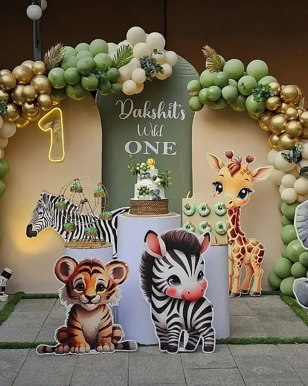 A perfect photo backdrop for a "Wild One" first birthday party. I use a combination of themed cutouts like baby lions and elephants, a full balloon arch, and personalized signage to create an immersive and picture-perfect jungle theme.