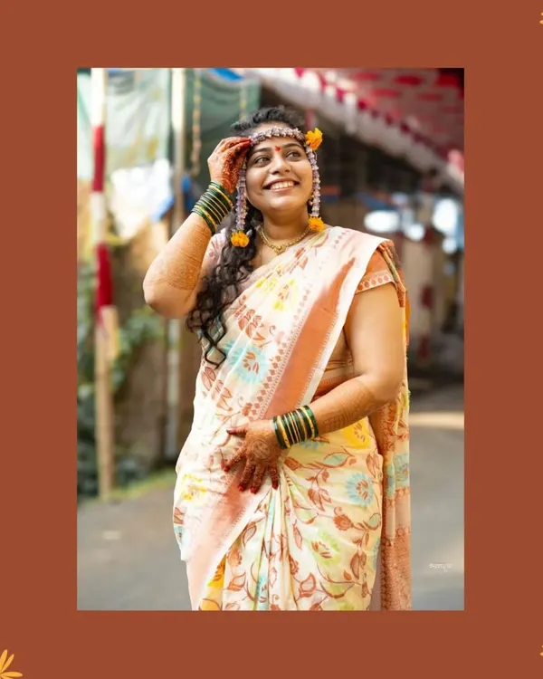 A candid shot of the bride during her Haldi ceremony. Her upward glance and happy smile perfectly capture the joyful anticipation of the wedding festivities.