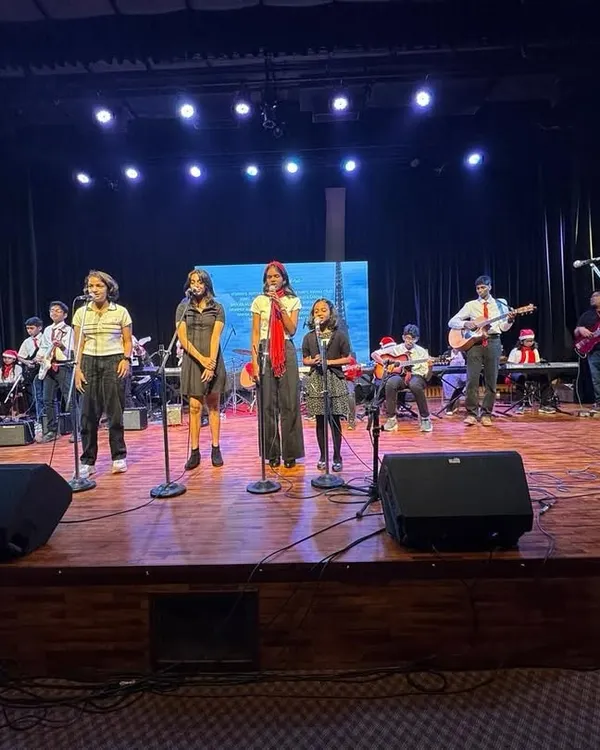 A full stage view of our band during a live concert. With multiple lead singers and a complete instrumental section, we can handle large venues and deliver powerful performances that get the crowd engaged for any corporate party or festival.