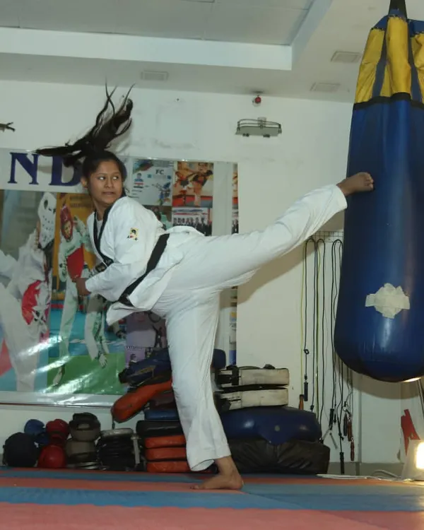 A student practices a powerful side kick on a heavy bag in our dojang. We focus on developing proper form and explosive power in every technique.