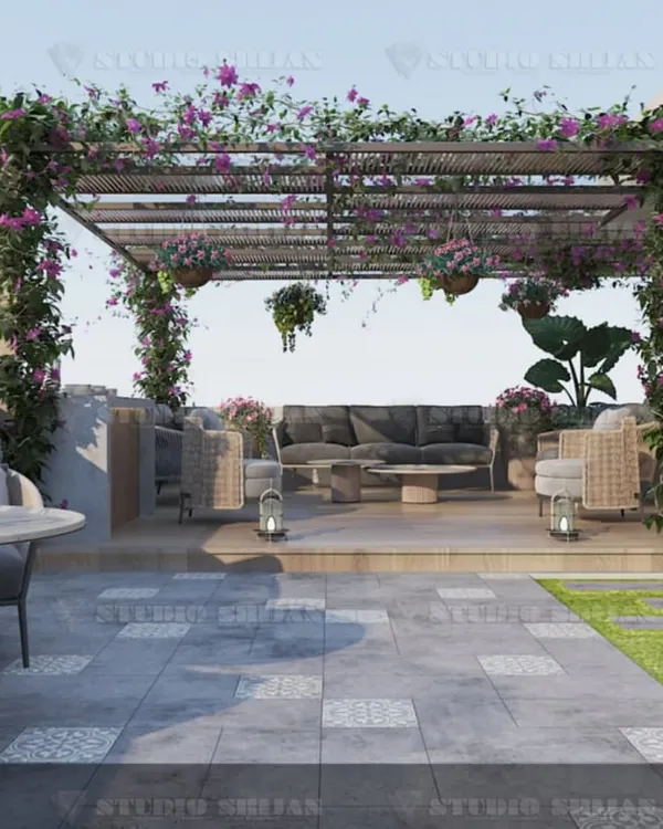 This terrace in Rajouri Garden is a complete outdoor living room, featuring a large pergola draped in flowering vines, comfortable sofa seating, and a dining area. It's the perfect urban escape.