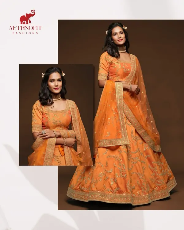 A close-up of the beautiful golden embroidery on my orange silk lehenga. I love how the threadwork catches the light, adding a touch of royalty.