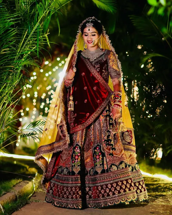 This is the quintessential bridal dream. I created a classic Marwadi bridal look with a focus on radiant skin that glows under the lights, bold kohl-rimmed eyes, and a deep red lip. The entire look, from the velvet lehenga to the intricate jewellery, comes together to create a truly royal presence.