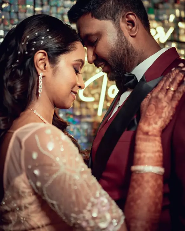 An intimate close-up of a couple dancing at their reception, surrounded by the warm glow of the decor.