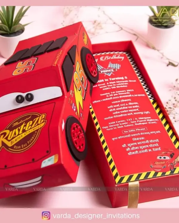 This 'Cars' themed birthday invitation is designed as a 3D model of Lightning McQueen. The box slides open to reveal the party details, making it an unforgettable invite that doubles as a toy for young guests.