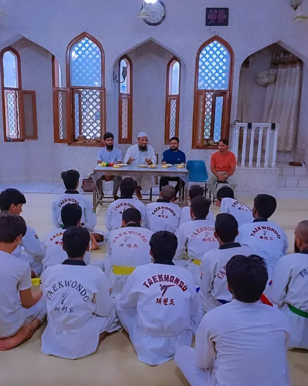 Students listen attentively during a belt distribution ceremony held at the Umar Bin Al-Khattab Masjid, a moment of shared respect and learning.