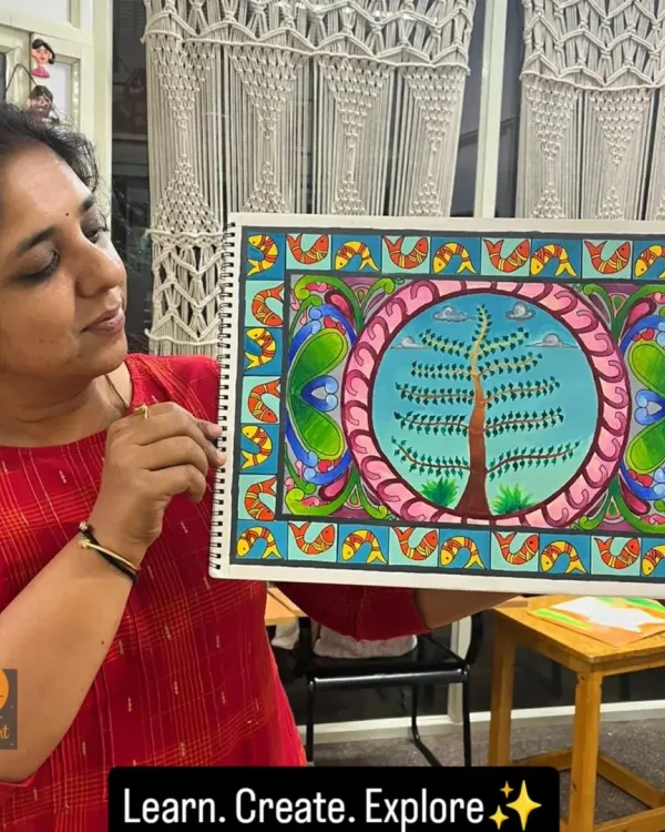 Here I am with a finished Madhubani painting, a style known for its intricate geometric patterns and themes from nature and mythology.