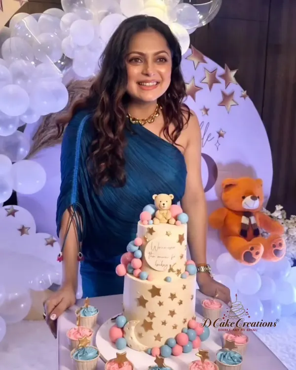A joyous moment with actress Drashti Dhami at her "Over the Moon" themed baby shower. We designed the two-tier teddy bear cake and matching cupcakes to be the sweet centerpiece of her celebration.