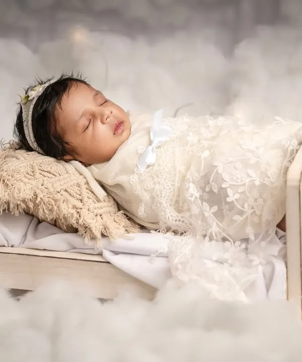 Drifting into the sweetest dreams. This newborn is nestled in a tiny wooden bed surrounded by soft clouds, a perfect example of my safe and creative fine art setups.