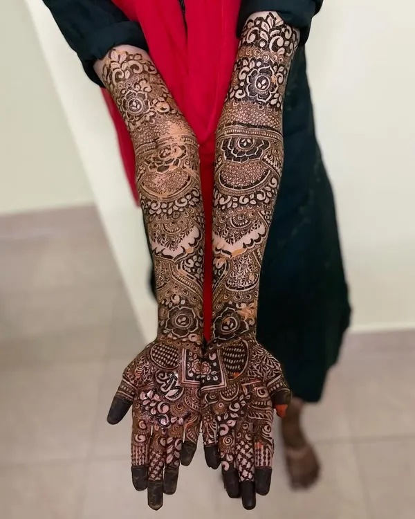This is the complete bridal mehendi for Anha's wedding. The design extends up the arms with a mix of floral elements, traditional motifs, and fine line work for a truly grand celebration.