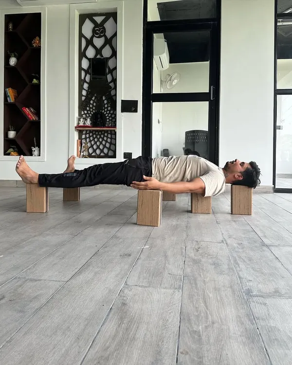 This pose, supported on blocks, is inspired by Bhishma lying on a bed of arrows. It is a powerful therapeutic asana for cardiac patients, as it opens the chest and supports the heart. This is an example of the deep, therapeutic knowledge we explore.