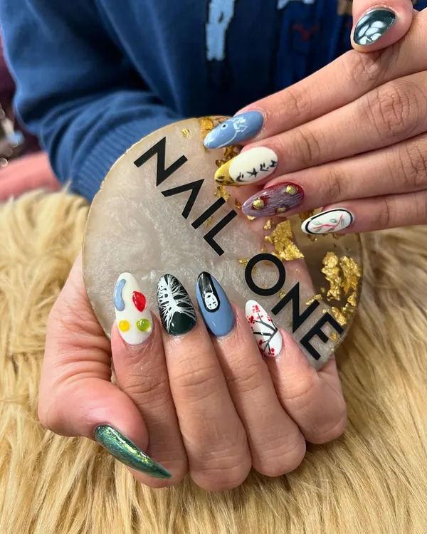 Another angle of our detailed anime-inspired nail art set. This view highlights the different characters and scenes on each nail, showcasing our ability to work with a diverse color palette and intricate line work on a small canvas.