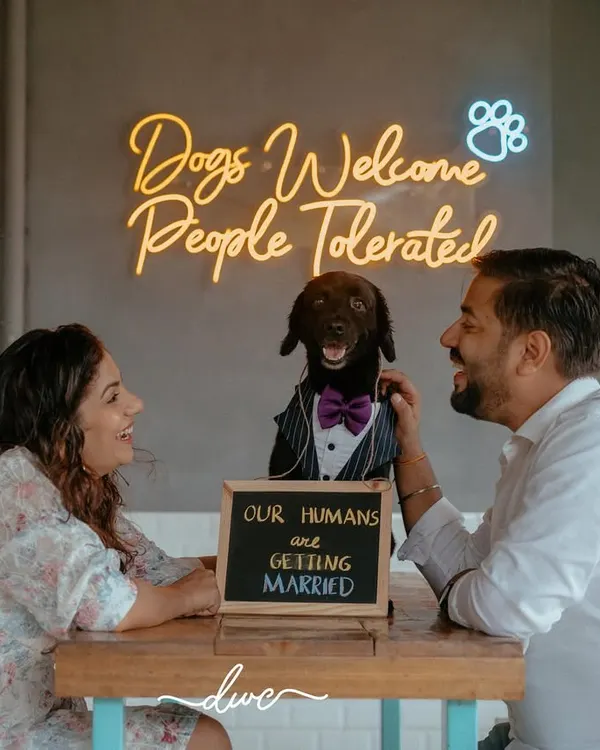 The perfect family portrait. This pre-wedding shoot includes the couple's furry friend, who proudly announces, "Our humans are getting married!"
