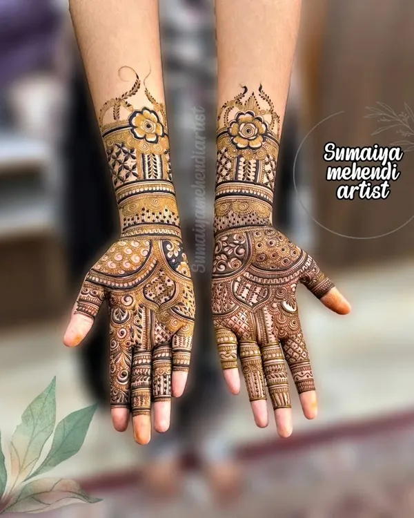 A beautiful Indian mehendi design with floral bands and a unique pattern on the palm.