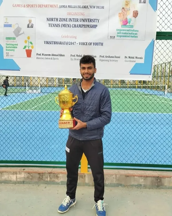 NTC player Udit Kamboj with his winner's trophy after dominating the North Zone Inter-University Men's Singles championship.