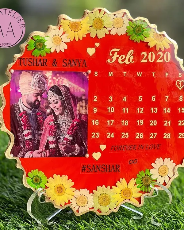 A beautiful way to mark your special day forever. This custom anniversary calendar frame captures a favorite wedding photo, the month you said "I do," and your wedding hashtag, all surrounded by preserved flowers.