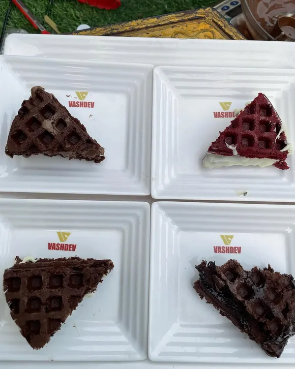 A platter of our assorted live waffles, a crowd-pleaser at any event. This image displays our variety, including classic chocolate, rich dark chocolate, and vibrant red velvet waffles.