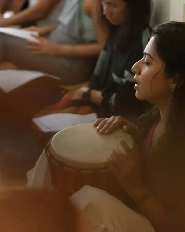 "Capturing the essence of devotion, the Bhakti Bhav." This moment shows me immersed in the feeling of kirtan, playing the djembe. It is in these moments of musical prayer that we can lose ourselves and find a deeper connection.