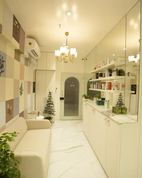 A view of our clinic's interior. We've created a clean, bright, and calming space where you can relax before your appointment. The mirrored wall reflects our extensive range of dermatologist-approved skincare products.