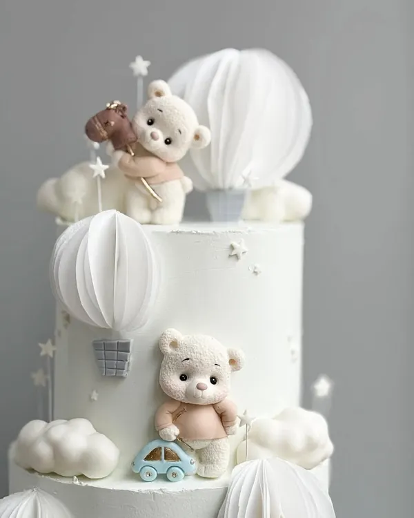 A close-up of the cutest teddy bear themed cake, with handcrafted bears and hot air balloons.