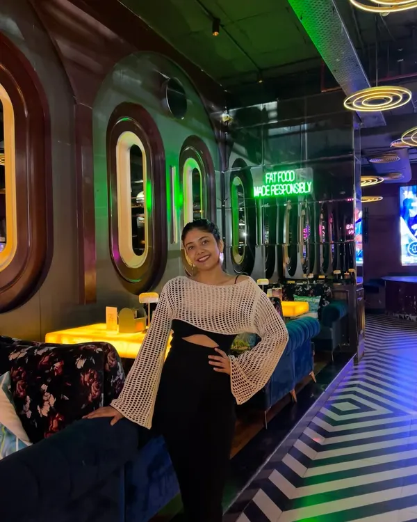 A casual night out look. This knit cutout top paired with a simple black skirt is comfortable yet stylish, perfect for dinner with friends.