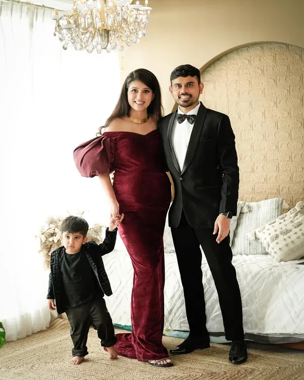 A classic family maternity portrait in our studio. The rich velvet gown and formal attire create a look of timeless elegance as this family of three prepares to become four.