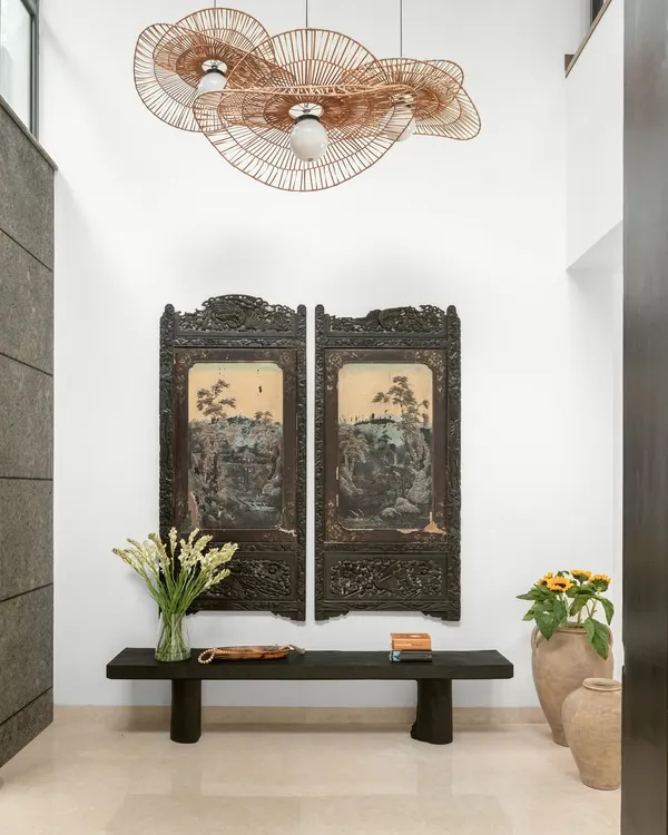 This double-height foyer is the heart of the home, where a restored fresco wall meets modern design. I paired these hand-painted antique panels with a bold, clean-lined bench to create an entrance that feels both welcoming and quietly striking, setting a tone of timeless luxury.