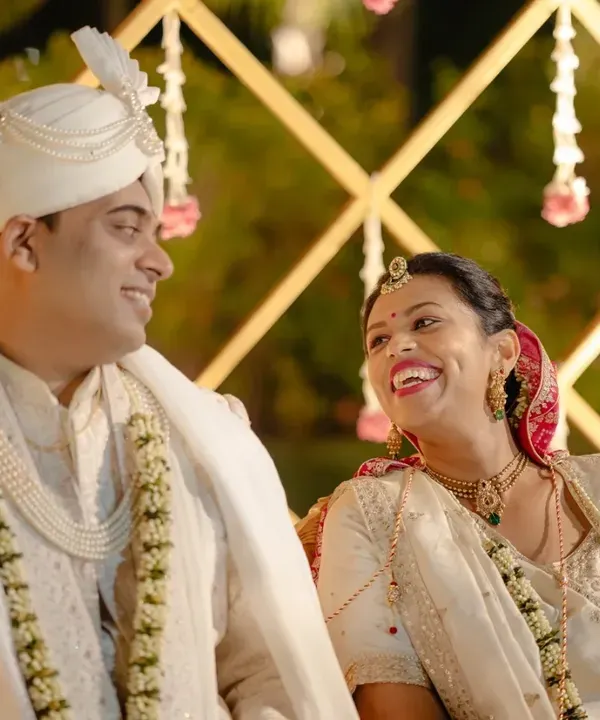 A candid moment of pure joy between the couple during their wedding ceremony. It's these unposed smiles that tell the real story.