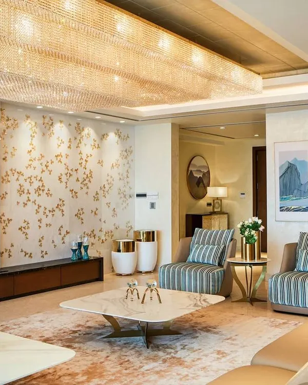 A glimpse into our Kingfisher Tower project in Bangalore, where we designed a living space that balances opulence with a warm, welcoming ambiance. The room features a massive custom crystal chandelier over a marble coffee table, bespoke furniture, and a curated art collection, all reflecting a lifestyle of sophisticated luxury.